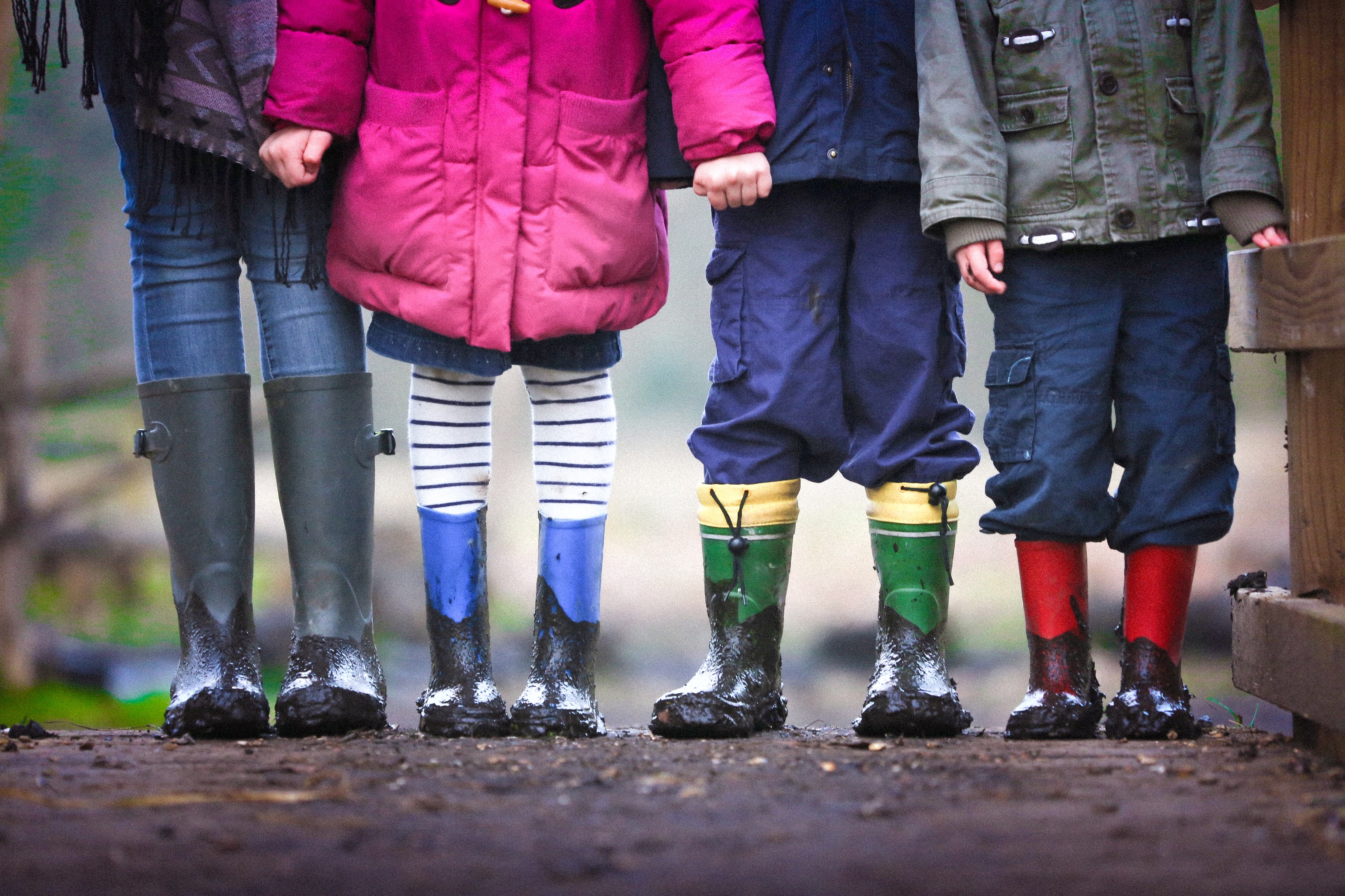 Managing the custody of children is focus of article; image features legs of 4 children wearing boots