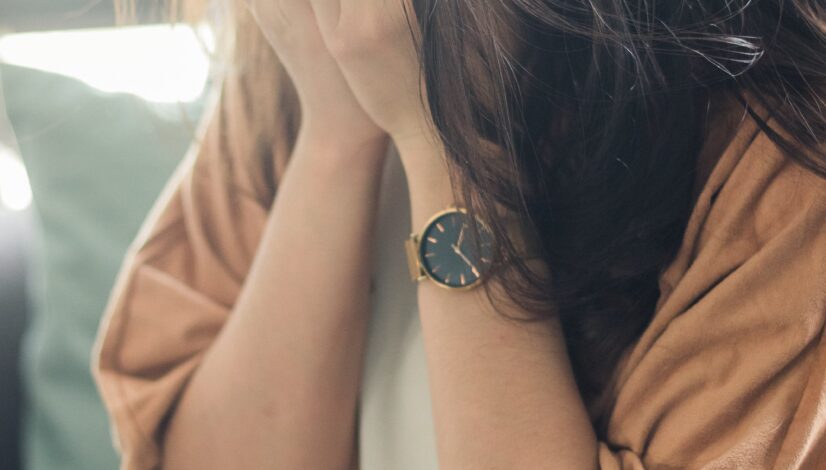 A crying woman with her hands over her face shows how hard conflict can be, especially during divorce